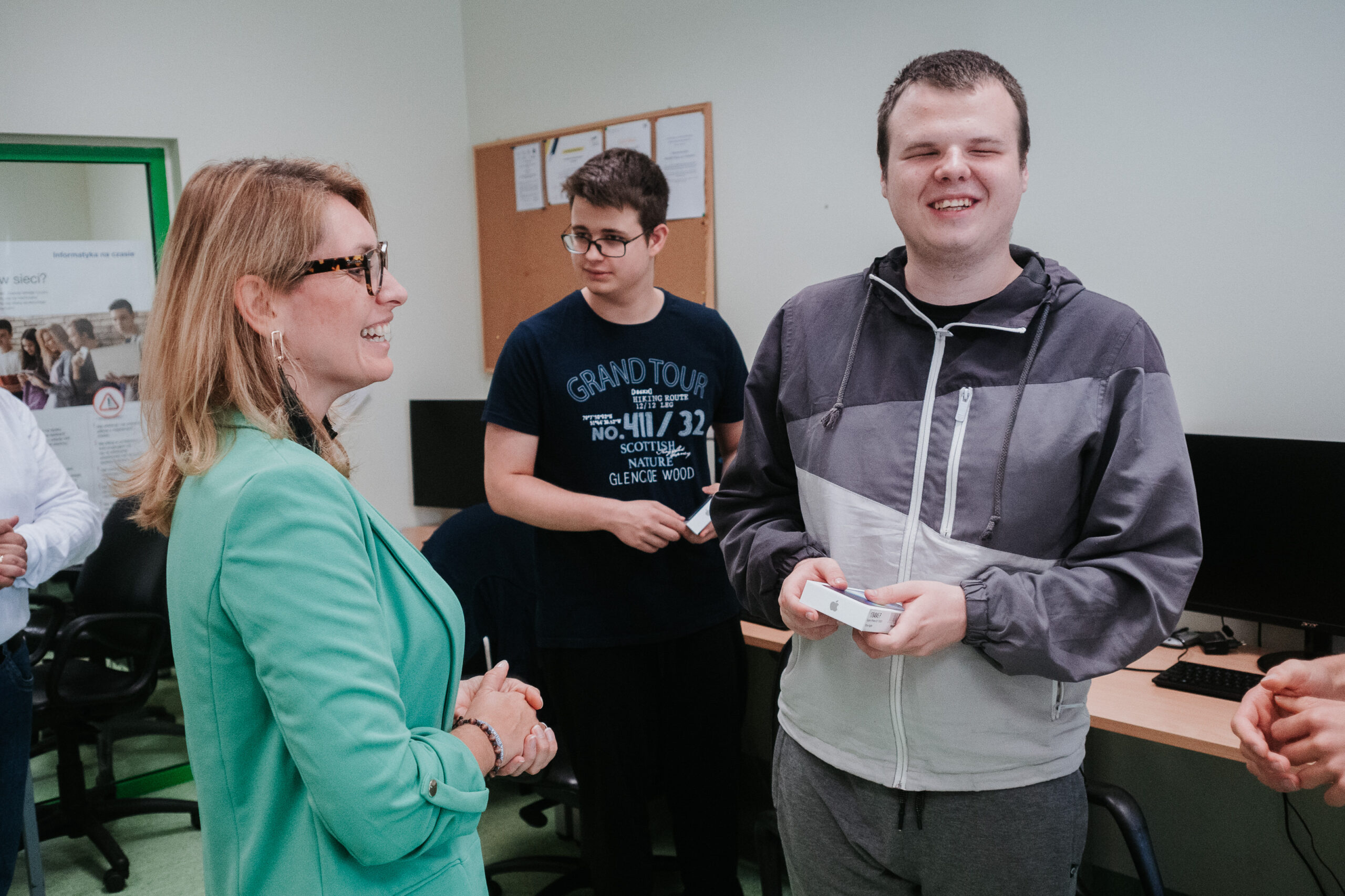 Kamila Miler-Zdanowska wręcza telefon uczniom.