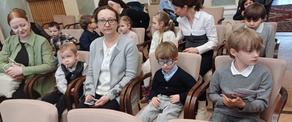 Przedszkolaki z paniami na widowni filharmonii.