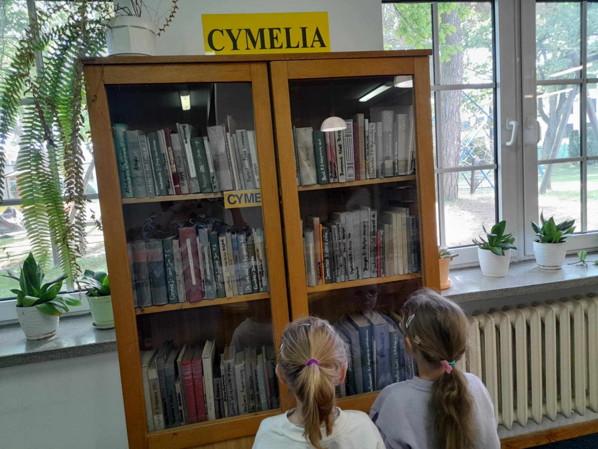 dziewczynki przy regale z książkami