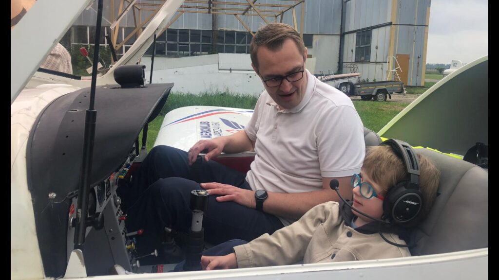 Chłopiec z pilotem w kabinie samolotu