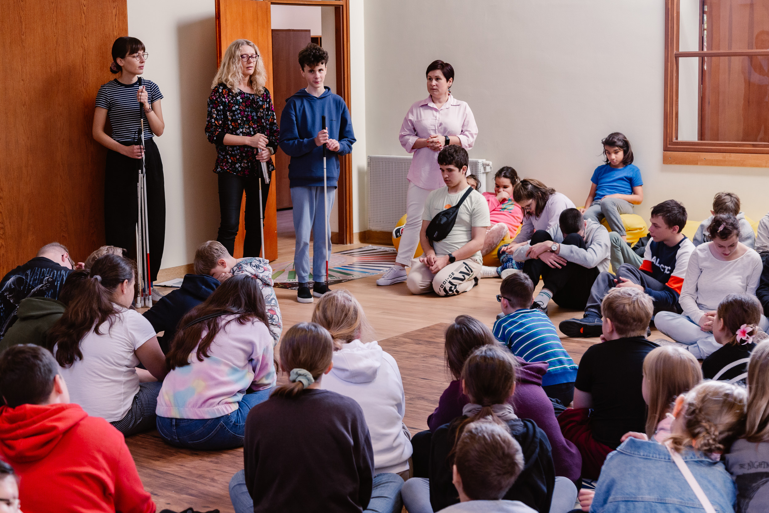 Niewidomy uczeń pokazuje białą laskę.