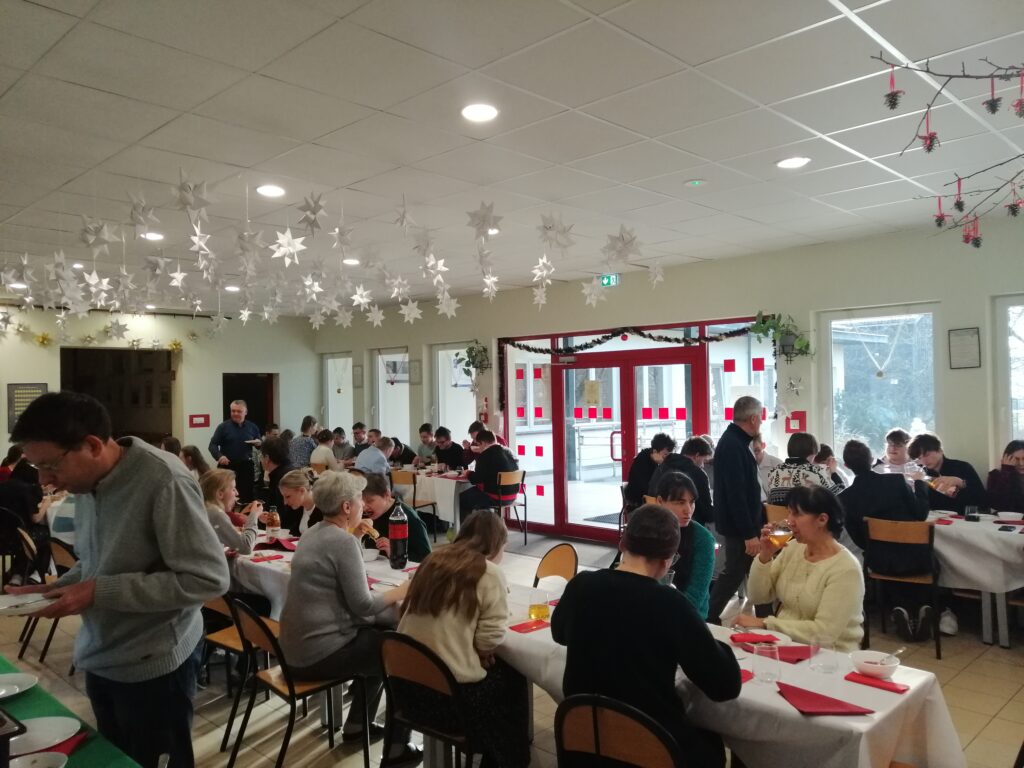 Uczestnicy spożywają pyszne dania świąteczne w miłej wesołej atmosferze.