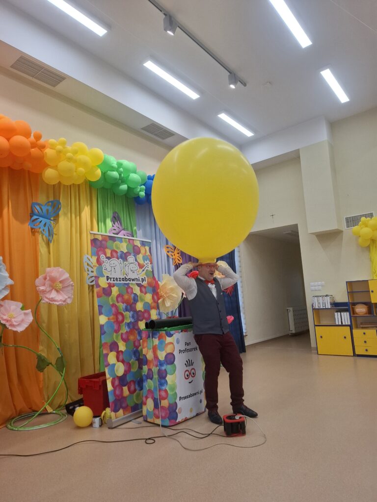 Pan ma na głowie bardzo duży napompowany żółty balon