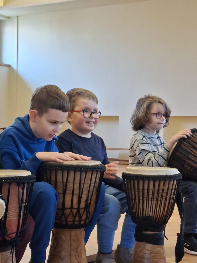 Uczniowie grają na bębnach