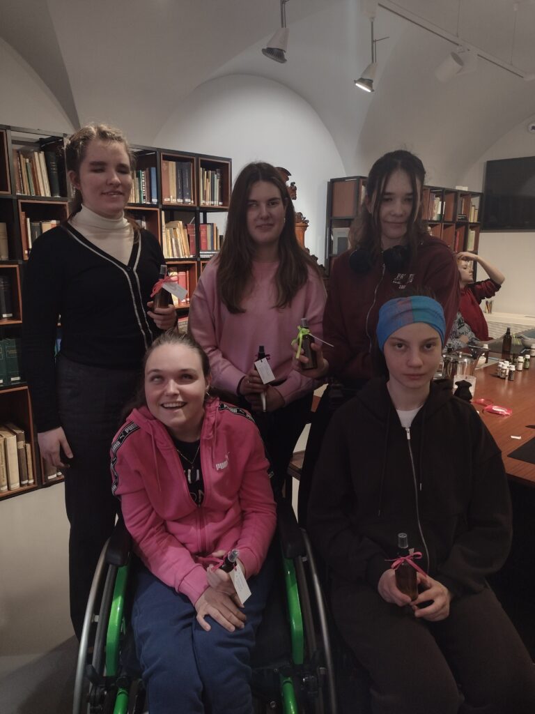 Uczestniczki warsztatów w Muzeum Farmacji dumnie prezentują własnoręcznie przygotowane i ozdobione flakoniki wód zapachowych, które udało im się skomponować po mistrzowskim opanowaniu „sztuki wyboru” odpowiednich olejków.